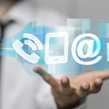 hand holding phone @ mail envelope signs symbols above internet fax services online fax services